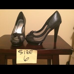 Black heels with mesh sides and lace-up front